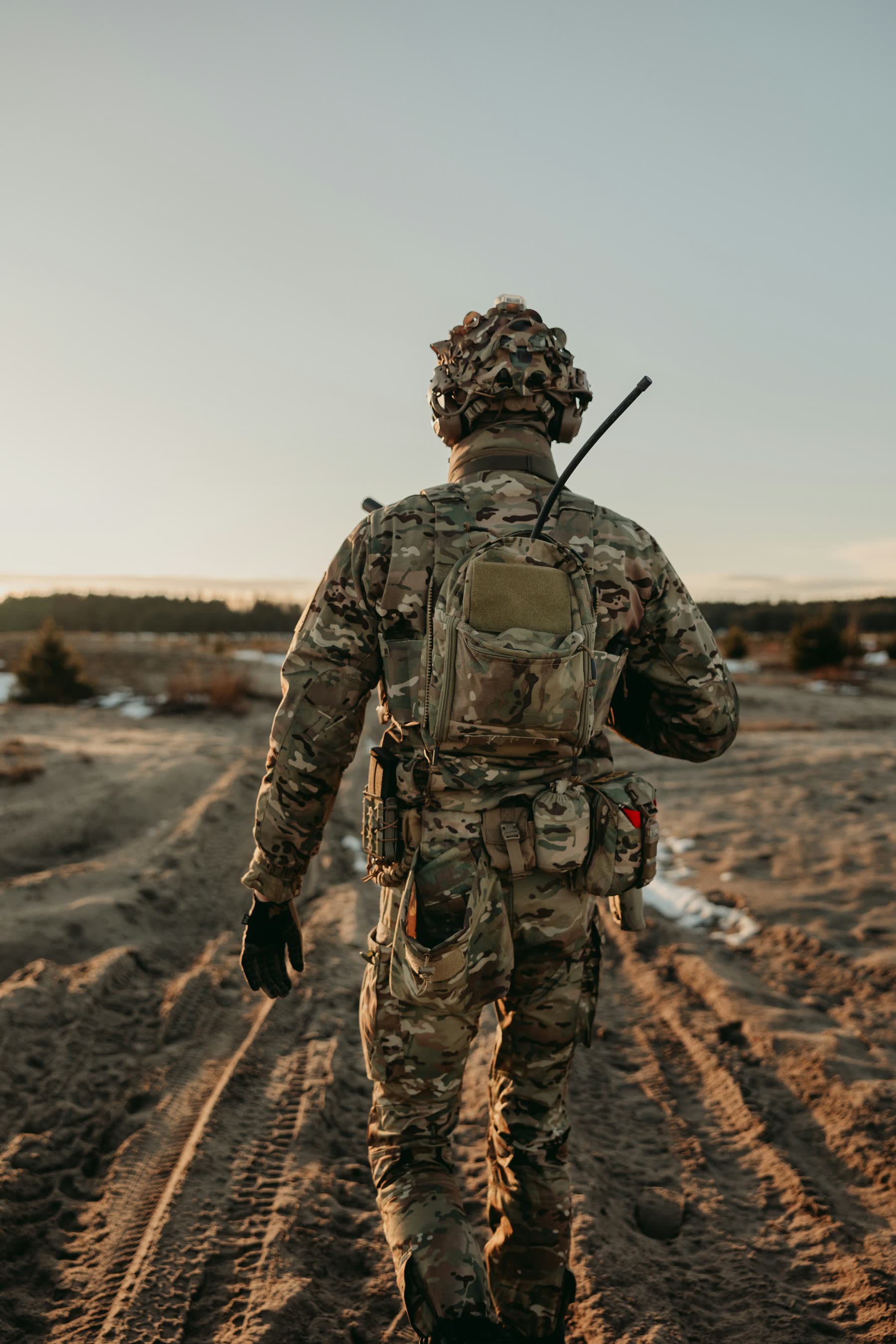 Soldier walking a trail with a ruck