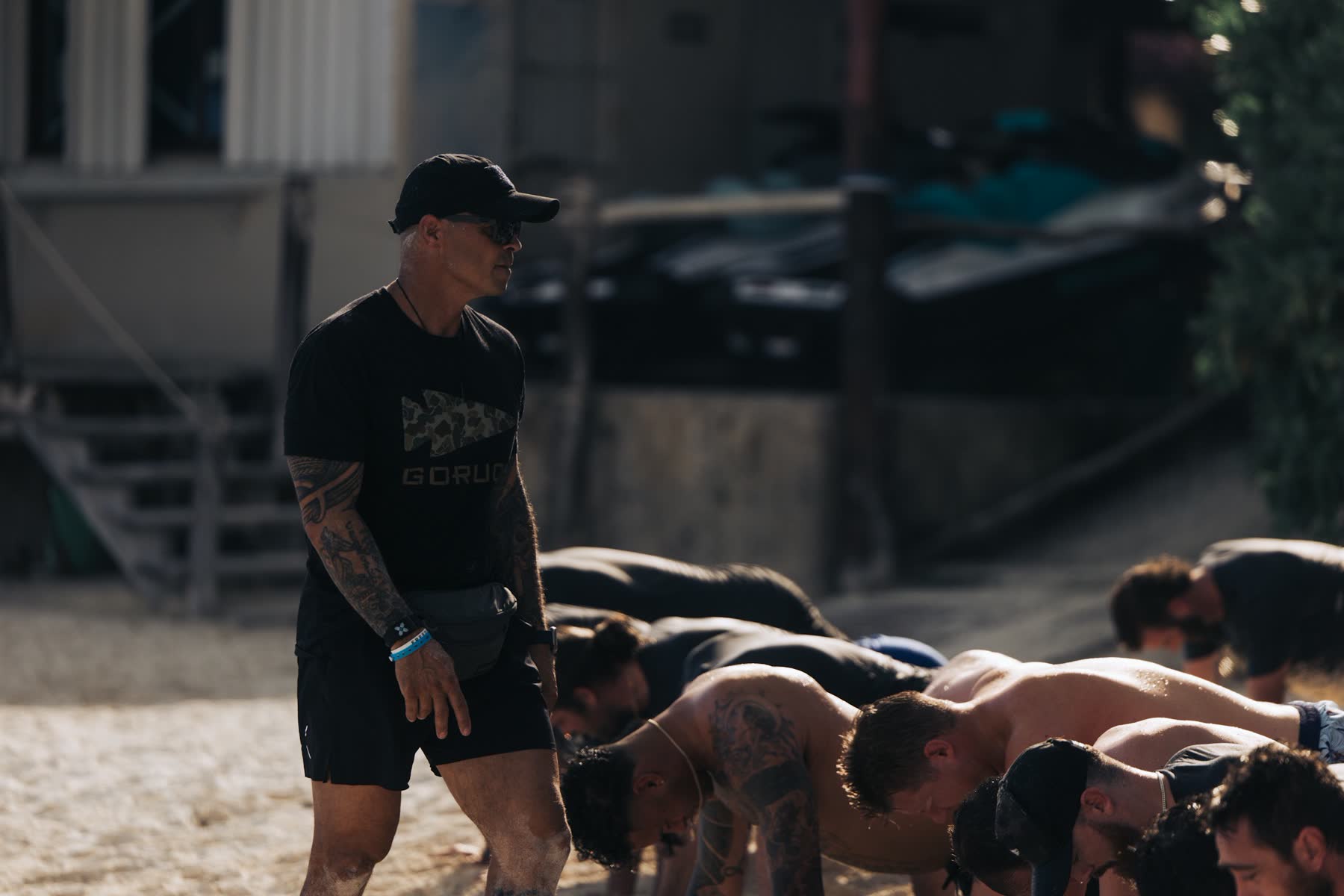 Coach leading a group through push-ups